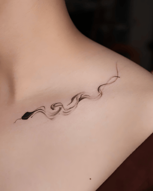 Xăm hình rắn mực loang, brush stroke tattoo, collarbone tattoo đẹp, xăm nghệ thuật tối giản: Nét rắn như vệt mực bay nhẹ trên xương quai xanh, mềm mại và nghệ thuật.