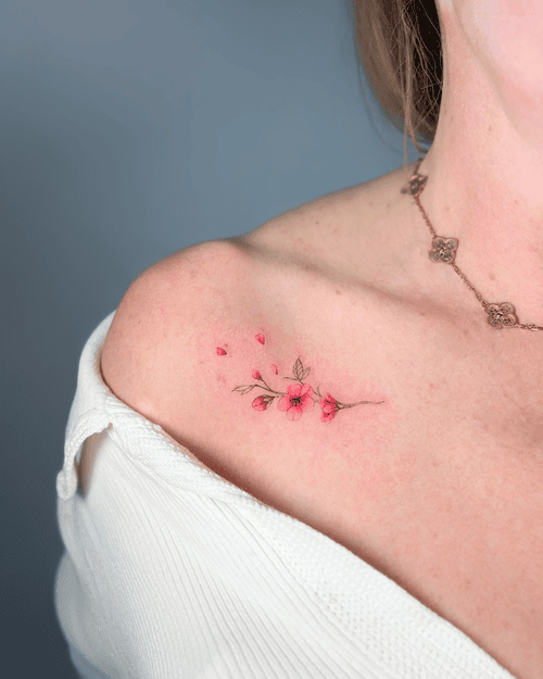 Xăm hình hoa anh đào mini cho nữ ở vai - Vẻ đẹp mong manh nhưng kiêu hãnh, tượng trưng cho sự thịnh vượng và triết lý về cuộc sống ngắn ngủi.